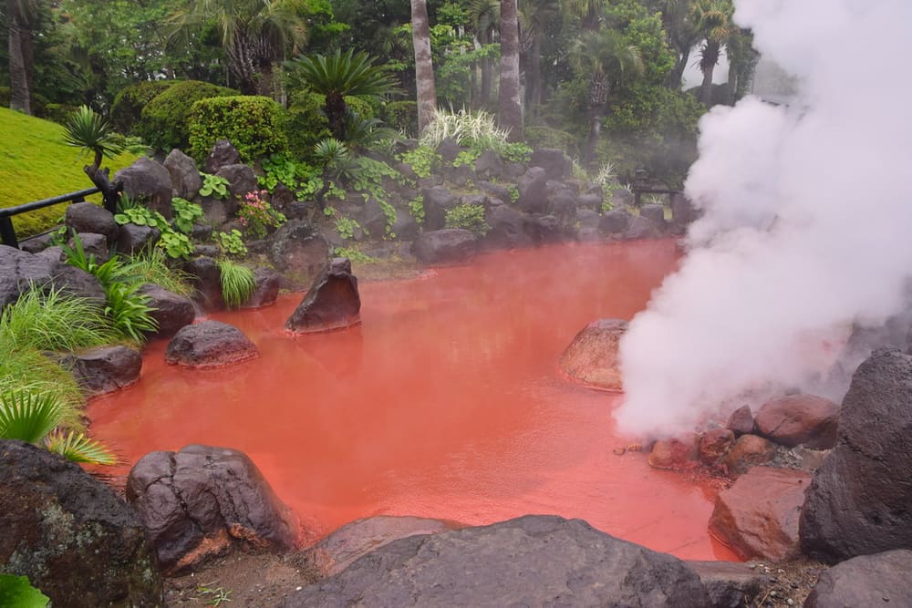 The steaming red water of the Blood Pond Hell, Beppu, Japan