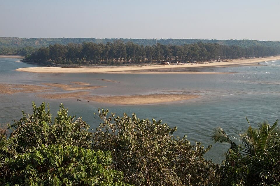 Querim beach and the Terekhol river mouth, northern Goa, India