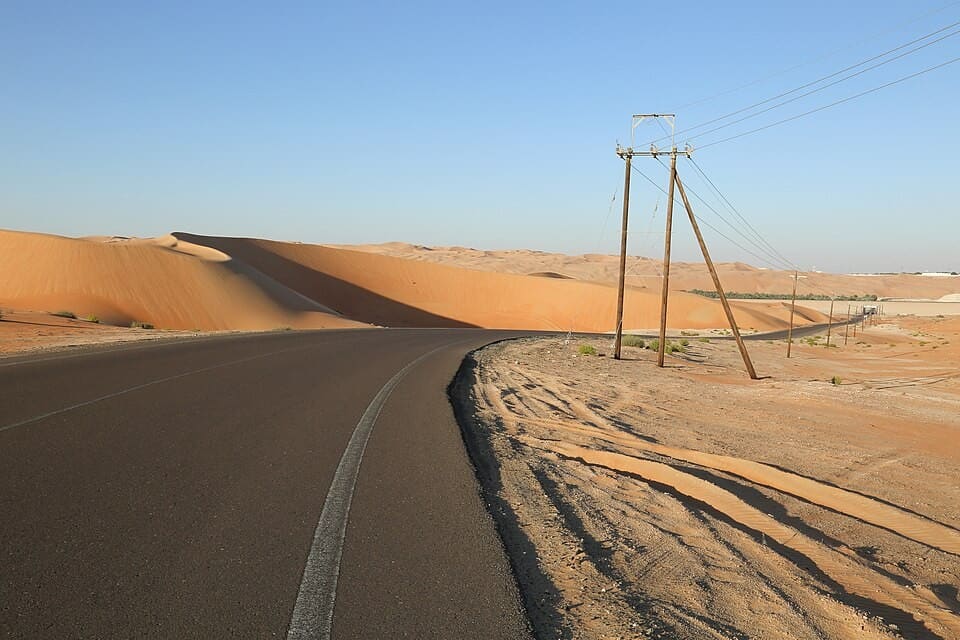 A road through the tall red dunes of the Liwa desert, Abu Dhabi, UAE