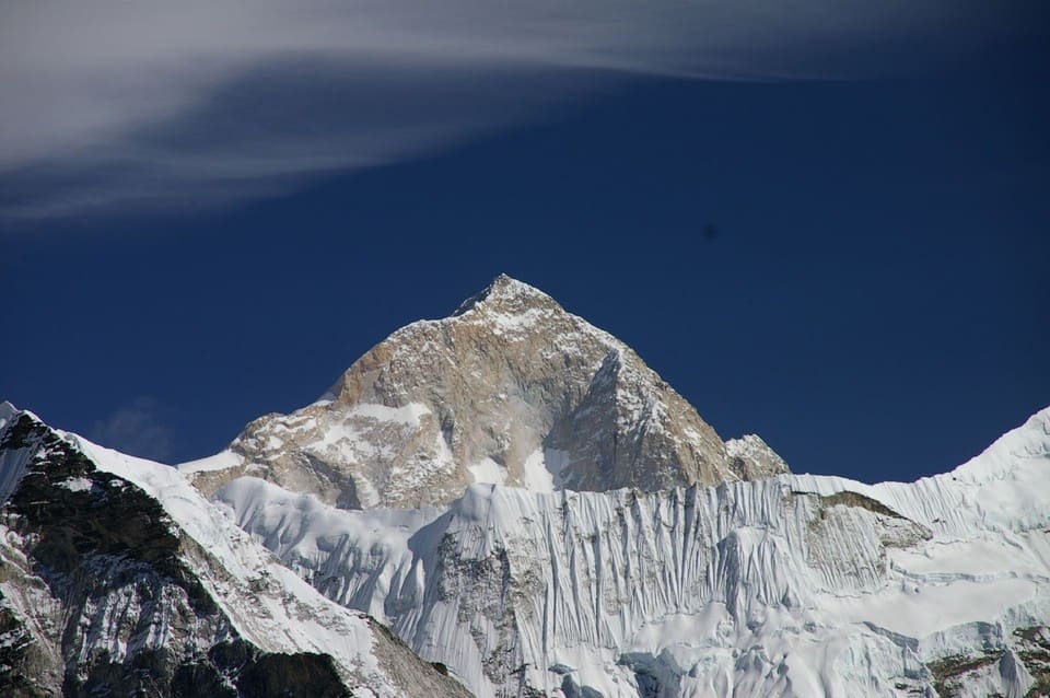 The granite summit pyramid of Makalu above an ice wall, Nepal